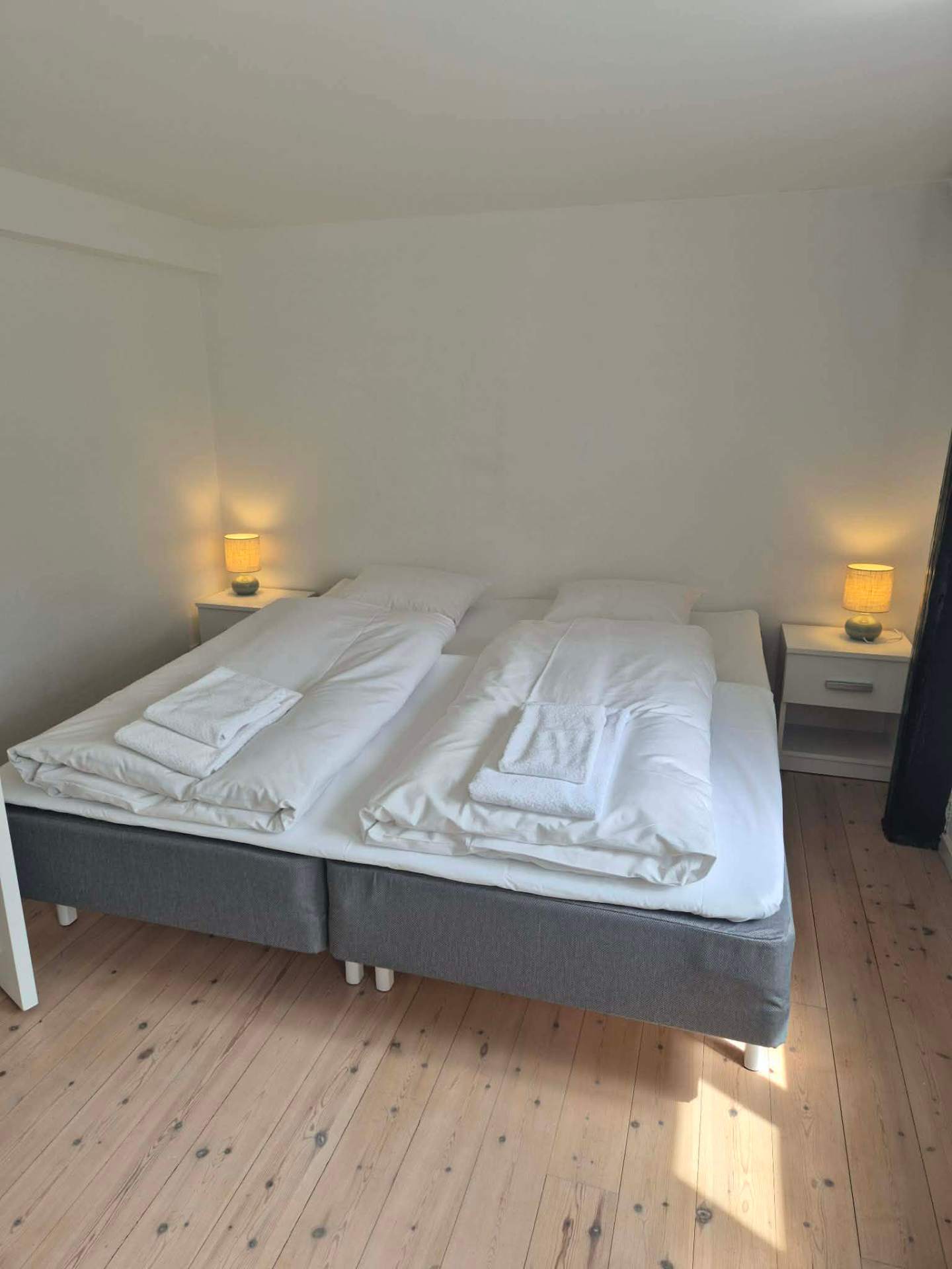 Soveværelse med to senge og natlamper